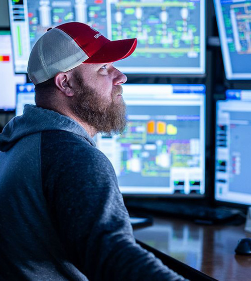 Ag-Tech worker works in front of multiple screens