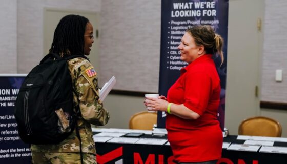 Military service member speaking with employer at a hiring event